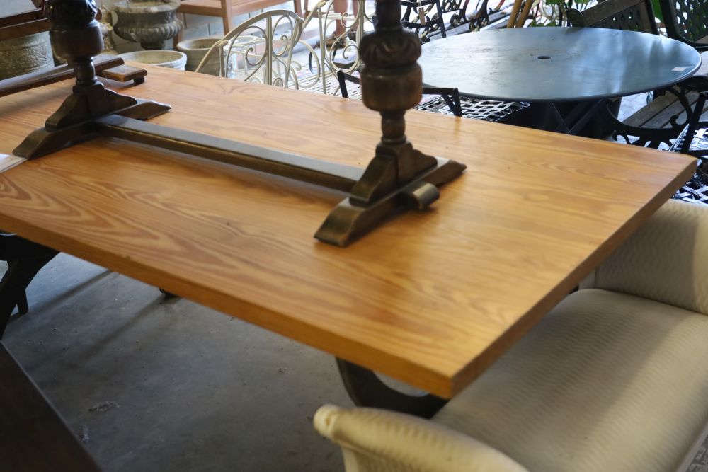 A pine dining table with wrought iron X frame base, W.200cm, D.100cm, H.78cm